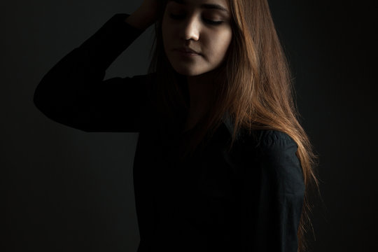 The young woman in the studio in a low key