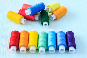 Coils of colorful sewing thread. Threads for sewing rainbow colors.