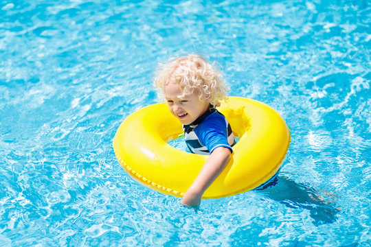 Child in swimming pool. Kids swim. Water play.