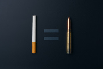 Smoking kills concept, cigarette and gun bullet with equality sign on dark background
