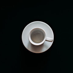 white coffee mug on black background top view