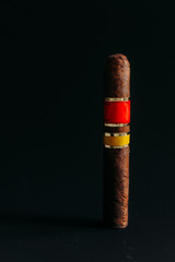 Cuban Cigar on structured black backgroundCuban cigar on structured black background, copy space