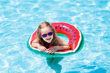 Child in swimming pool. Kids swim. Water play.