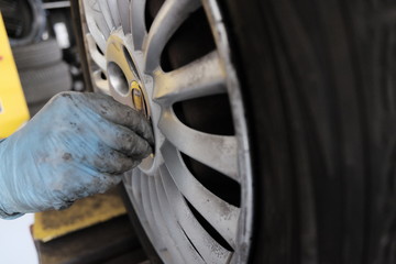 Fototapeta na wymiar tire repairer replaces tire