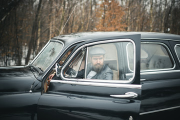 Retro collection car and auto repair by mechanic driver. Bearded man and sexy woman in car. Travel and business trip or hitch hiking. Escort of girl by security. Couple in love on romantic date
