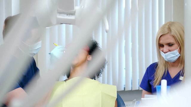 Dentist and his assitant working in private practice.