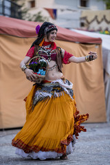 Fototapeta na wymiar Woman dancing oriental dance on the street