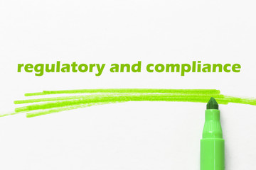 regulatory and compliance word written with green marker