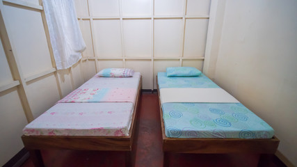 Budget Triple Hostel Room. Two beds. Asian country.