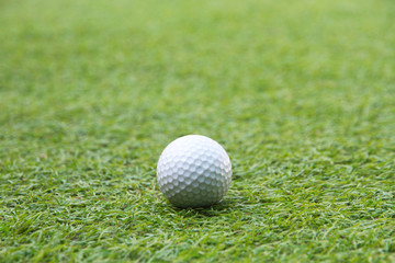 Golf ball in grass green 