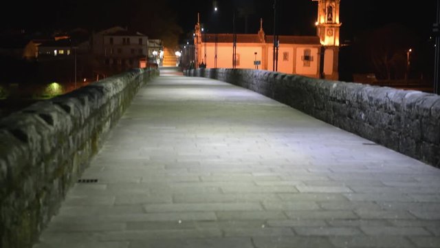 Night view of Roman bridge crossing the Rio Lima in Ponte de Lima. Camino de Santiago - Portugal.