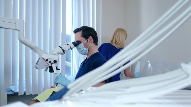 Dentist and his assitant working in private practice.