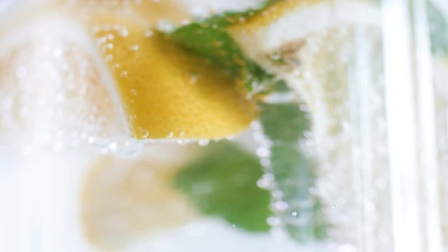 Macro 4k footage of camera slowly defocuses on bubles in lemonade