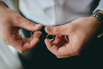 the bridegroom holds in the hands of wedding rings. preparation of the groom