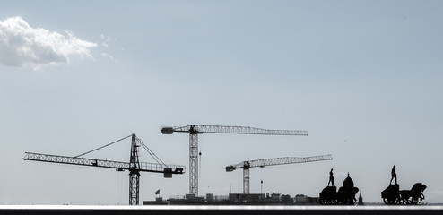 cranes and figures at the skyline of Madrid, spain
