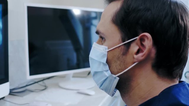 Man dentist looking at x-ray in private practice.