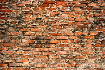 Background of cracked warehouse brick wall texture.