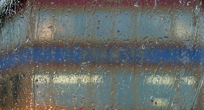 Facade seen through a window with raindrops