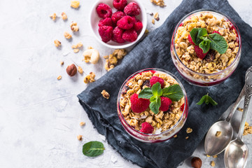 Obraz na płótnie Canvas Yogurt parfafait with granola and raspberries top view.