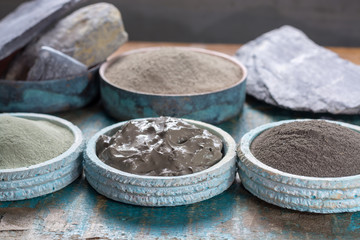Ancient nature minerals, different types of clay used for skincare, spa treatments, face masks, gray, black, green and blue mud, close up
