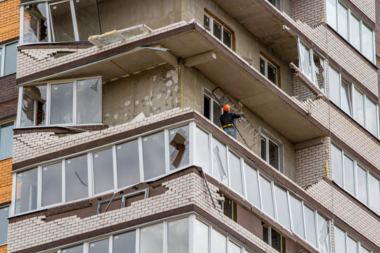 Obninsk, Russia - April 22, 2018: Damage to loggias on a 20-storey house as a result of a strong hurricane wind. Workers dismantle damaged structures