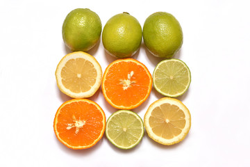 Fototapeta na wymiar Fresh sliced lemon, lime and orange on a white surface