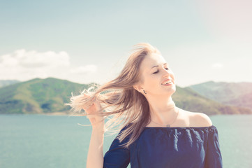 Fototapeta na wymiar Portrait of beautiful woman beside a lake