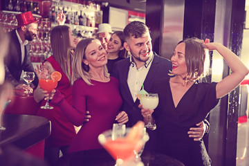 Guy with two girls partying in bar