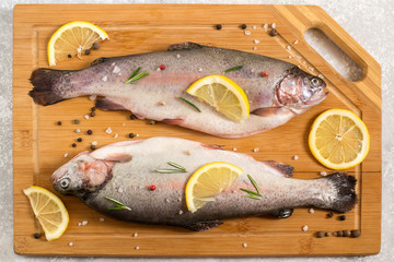 Two fresh trout and ingredients for cooking
