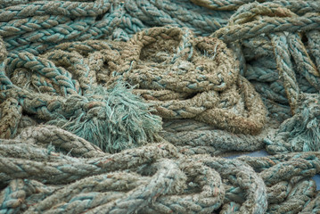 Ship’s mooring rough green ropes