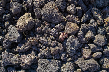 Abstract dark background, natural lava stone texture close up