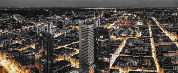 High quality black and white aerial panoramic view of Frankfurt, Germany at dusk. Yellow street...