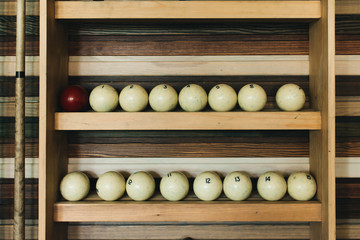 Balls for pool billiards on the shelf. Balls for Russian billiards. Soft focus.