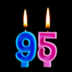 Burning birthday candles in the form of 95 ninety five figures for cake isolated on black background. The concept of celebrating a birthday, anniversary, important date, holiday