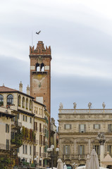 View of the Piazza delle Erbe in center of Verona city, Italy and Gardello tower in background (Market square)
