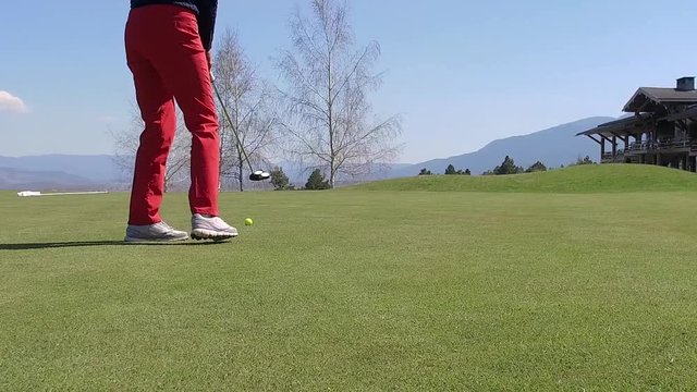 Golf player strikes ball on golf course  SLOW MOTION