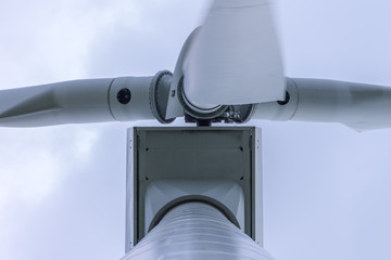 An electric power generator, a wind-operated, generator against the sky