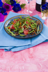 salad with arugula and salmon, dressed with sauce and grapefruit. Romantic dinner and flowers. card