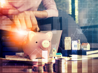 Saving money concept.Close up hand putting coin into piggy bank for saving money.young smart woman holding money coin and prepare to put the coin in piggy bank.