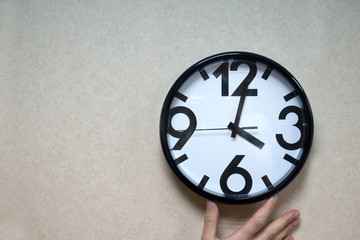 Large white clock with arrows.