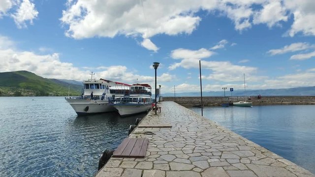 Boat and port from daily tour of Ohrid lake. Ohrid is famous for its unesco listed historical center and beautiful lake separating Macedonia from Albania