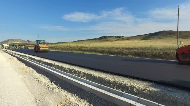 Road rollers flattens asphalt. Steamrollers smoothing hot asphalt. Paving. Asphalting. Machines for asphalt. Street repair, reconstruction, construction