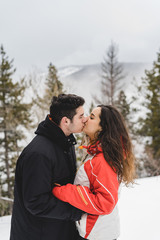 Couple kiss in snowy landscape