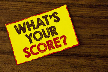 Handwriting text writing What Is Your Score Question. Concept meaning Tell Personal Individual Rating Average Results written on Yellow Sticky note paper on the wooden background.
