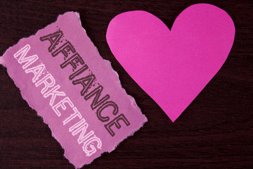 Handwriting text writing Affiance Marketing. Concept meaning joining two or more companies in same field mutual goal written on Tear Sticky Note Paper Piece on wooden background Heart next to it.