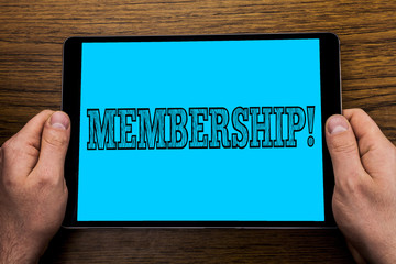 Text sign showing Membership. Conceptual photo Being member Part of a group or team Join organization company written on Tablet Screen holding in Hand on wooden background.