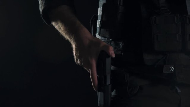 Spec ops police officer SWAT in black uniform studio