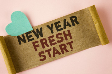 Word writing text New Year Fresh Start. Business concept for Time to follow resolutions reach out dream job written on Folded Cardboard paper piece on plain background Heart next to it.