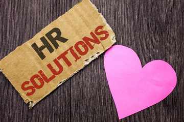 Handwriting text Hr Solutions. Concept meaning Recruitment Solution Consulting Management Solving Onboarding written on Cardboard Piece on the wooden background with Love Heart.