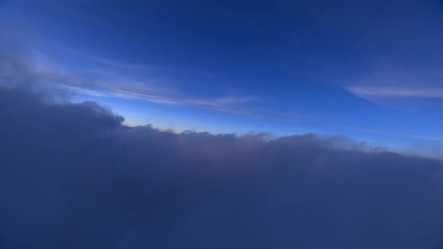 Tilting flight through clouds at dawn
